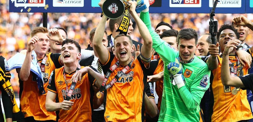 Players celebrating with trophy after victory