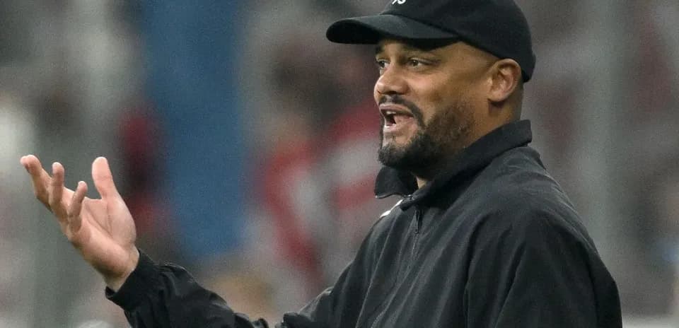 Coach gesturing during a football match on the sidelines