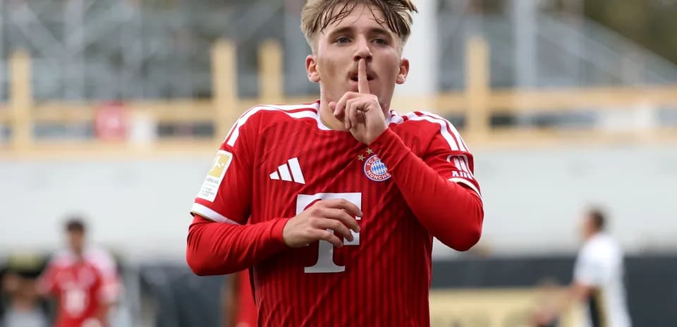 Player celebrating goal with shushing gesture