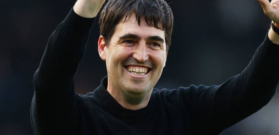 Coach celebrating with raised arms after match
