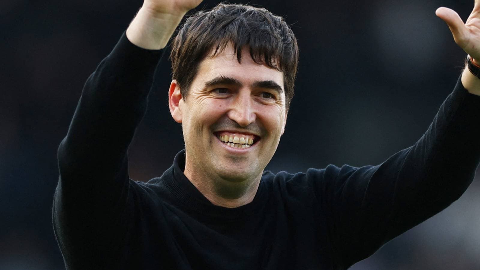 Coach celebrating with raised arms after match