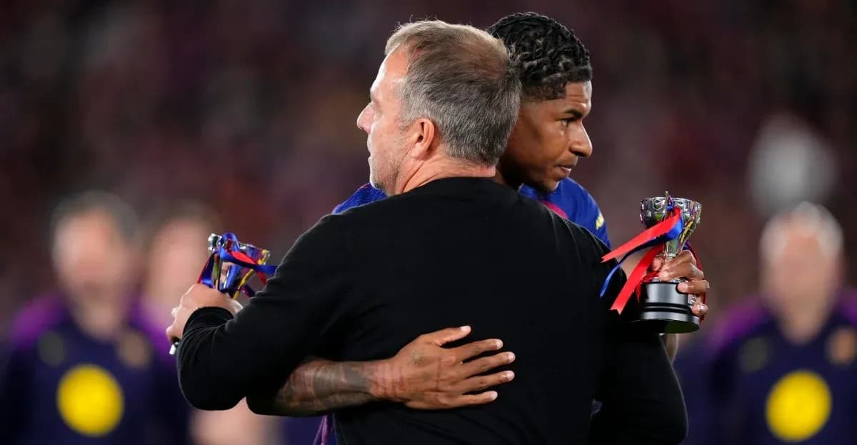 Coach embracing player holding trophy after match