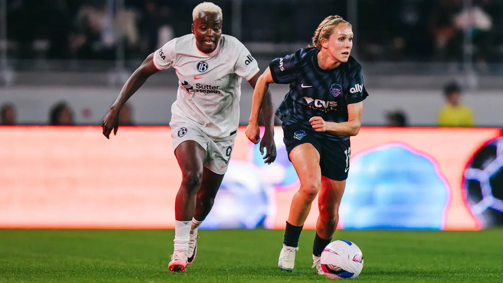 Two players competing for the ball in match