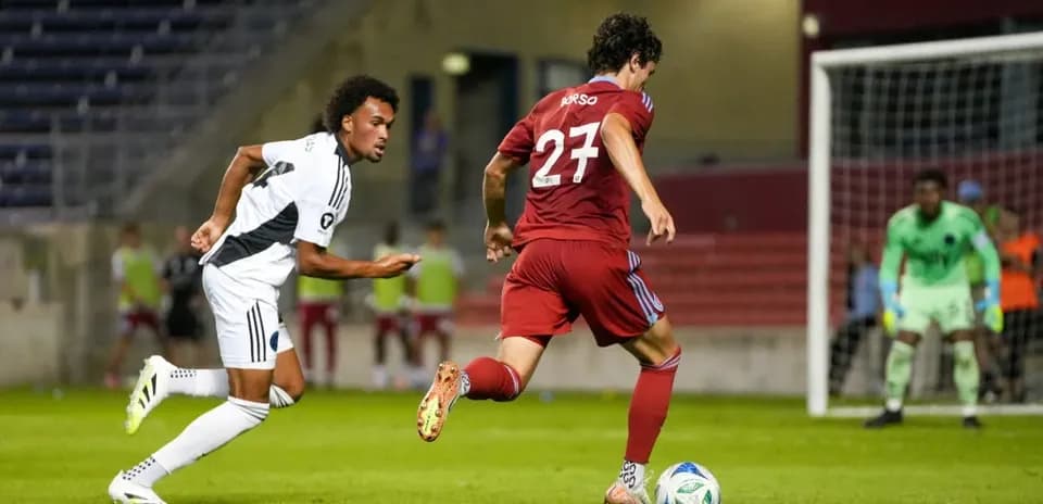 Two players competing for the ball in match