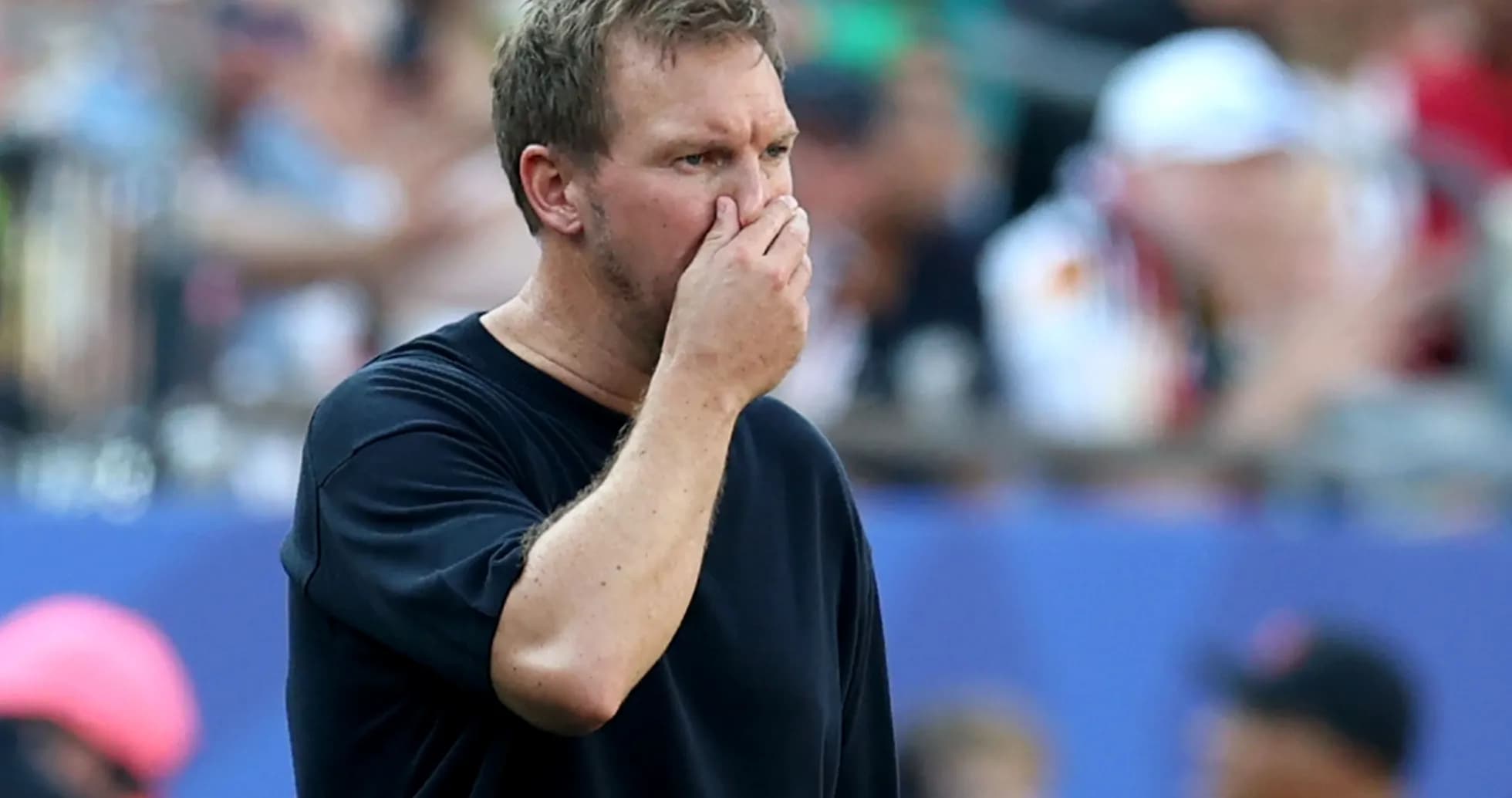 Coach observing the match with hand on face