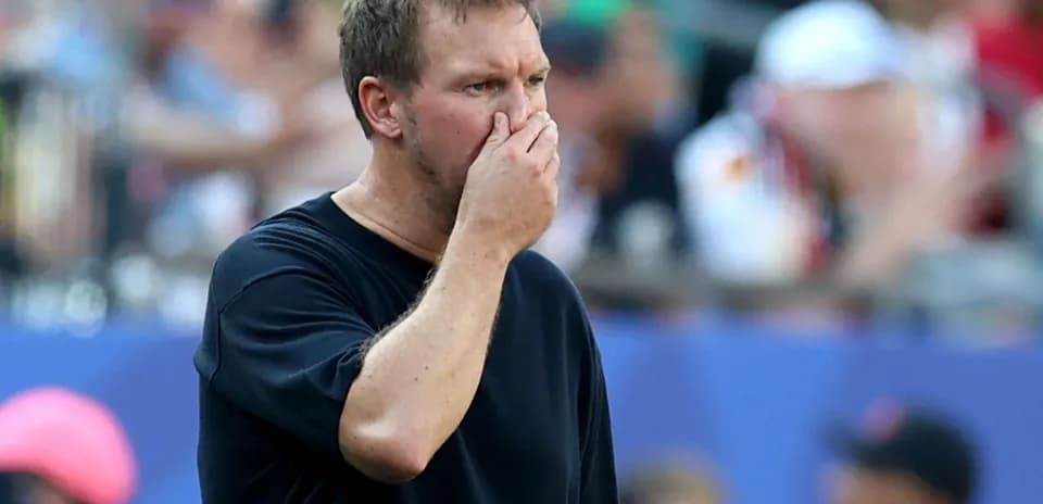 Coach observing the match with hand on face