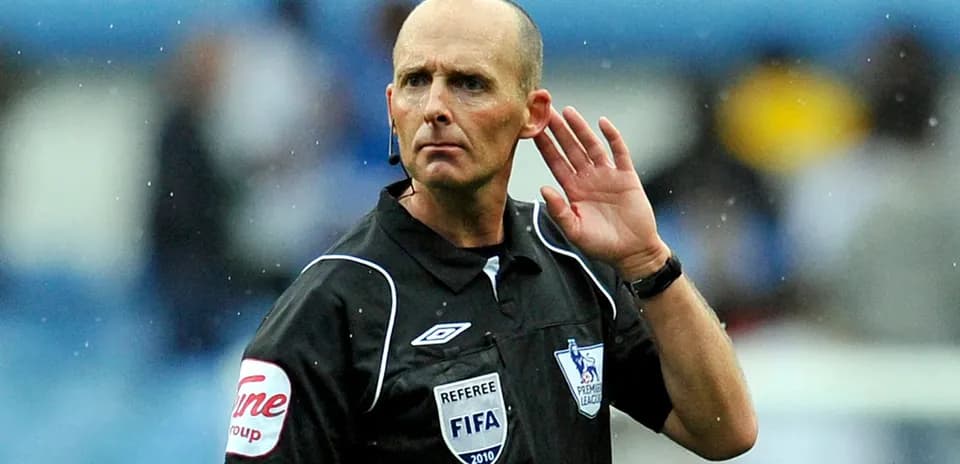 Referee signaling during a football match