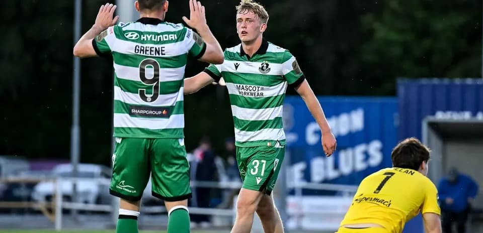 Two players celebrating a goal on the field