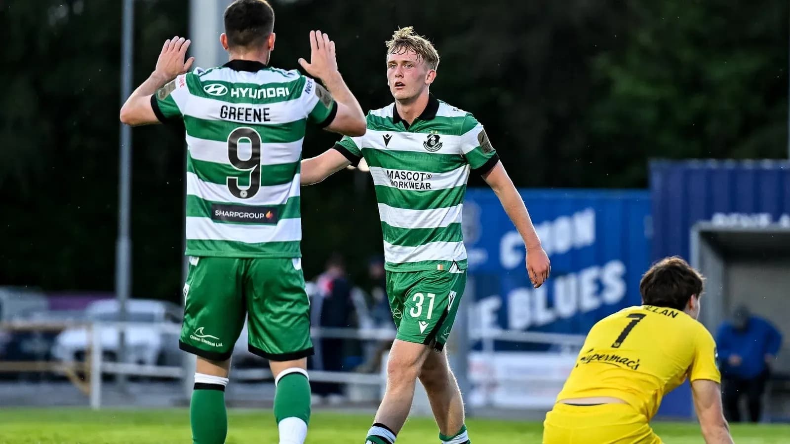 Two players celebrating a goal on the field