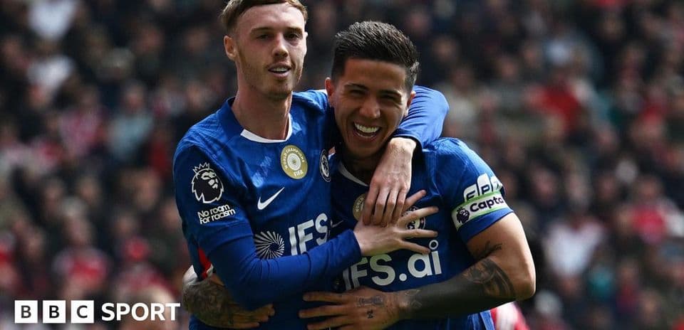 Two players celebrating a goal on the field