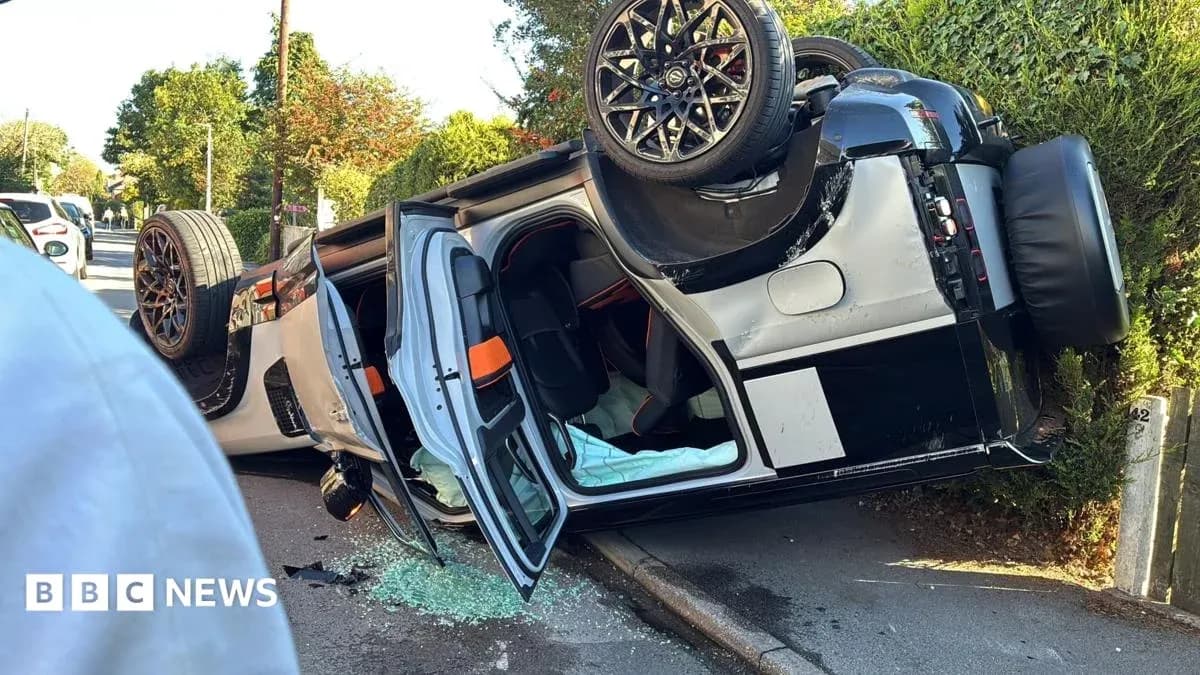 Upside-down car with shattered glass on road