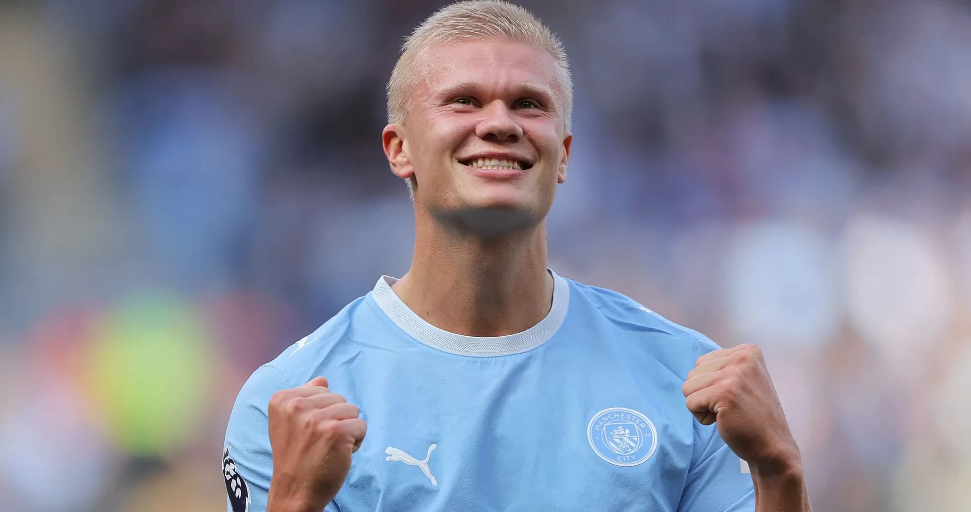Player celebrating in Manchester City kit on pitch