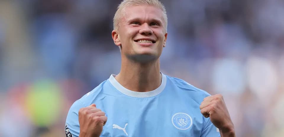 Player celebrating in Manchester City kit on pitch