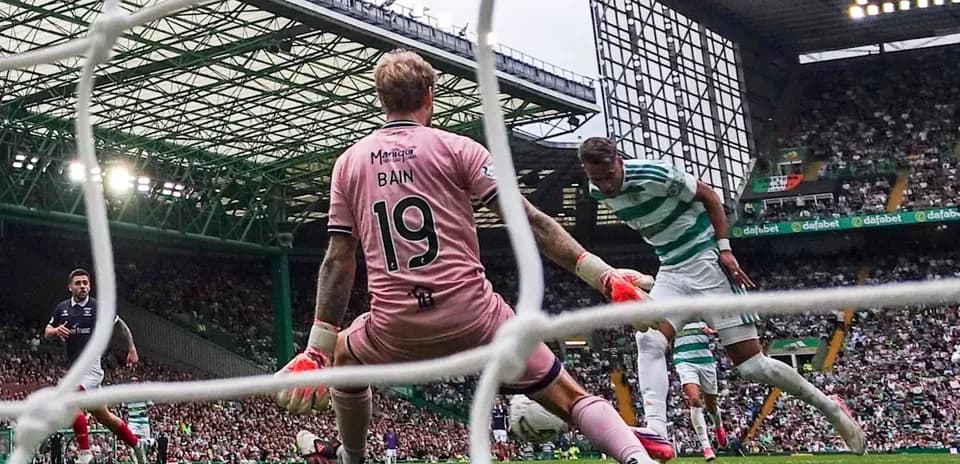 Goalkeeper Bain attempting to block a shot on goal