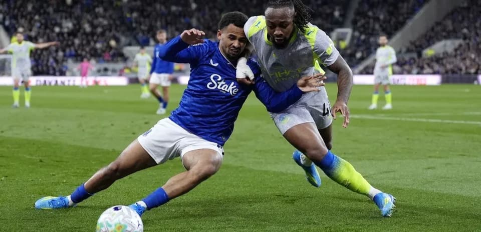 Two players competing for the ball on field