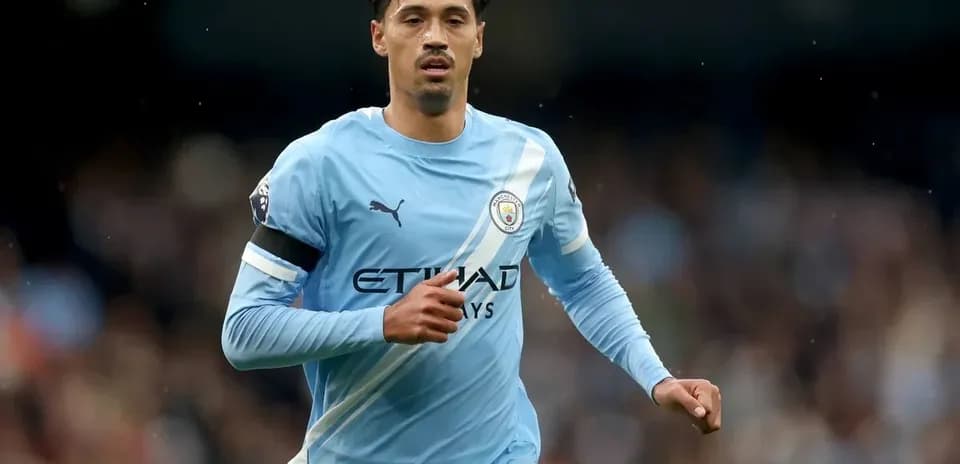 Player running in Manchester City jersey during match