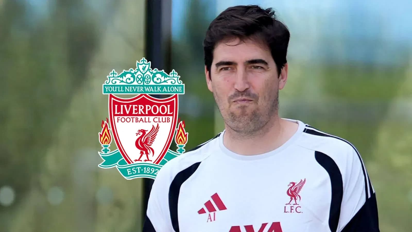 Coach in Liverpool FC training gear with club logo