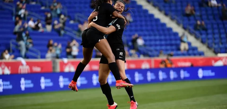 Players celebrating during NWSL match