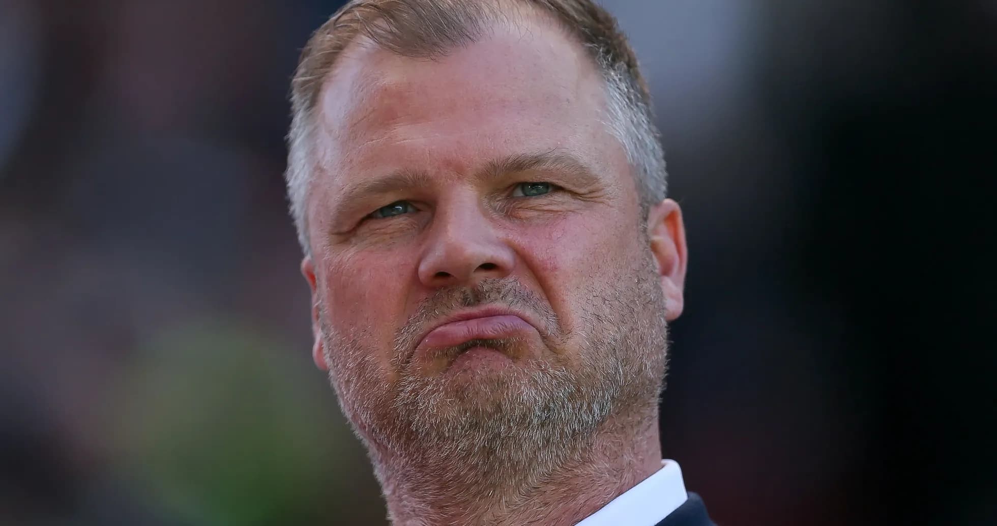 Coach with serious expression during match