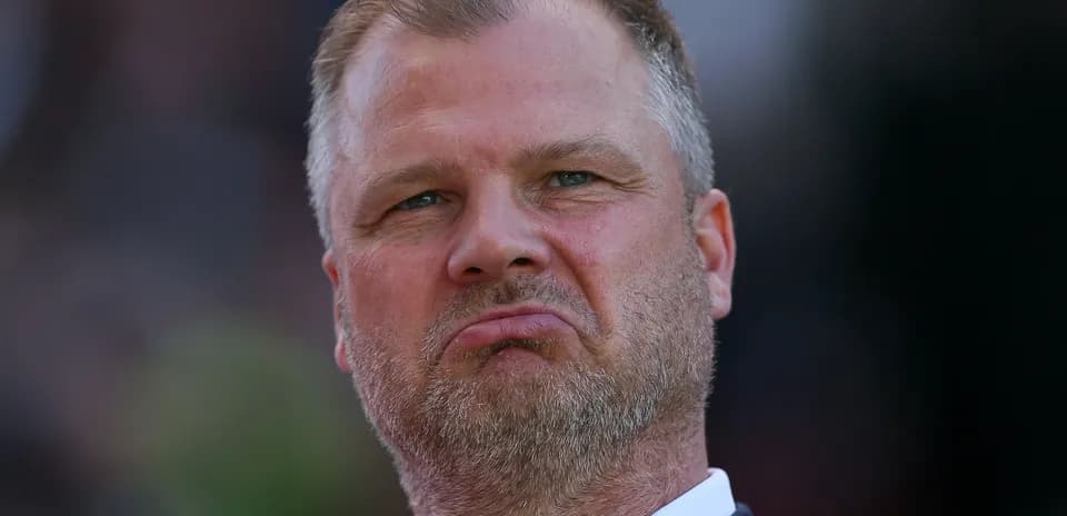 Coach with serious expression during match