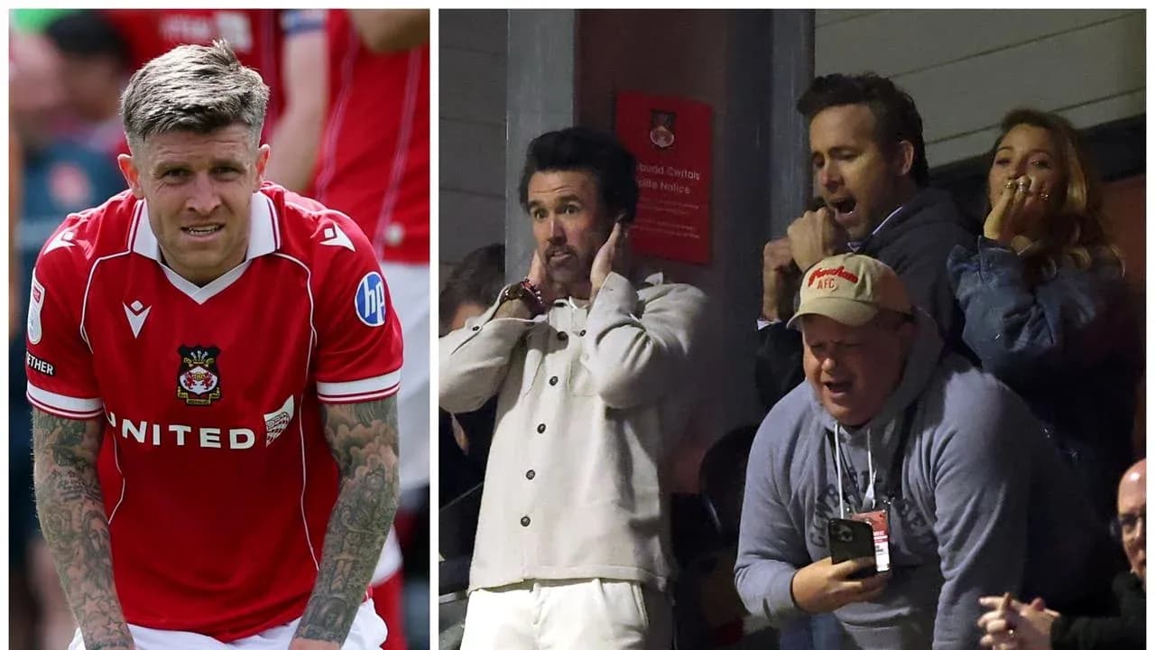 Wrexham player on pitch and fans reacting in stands