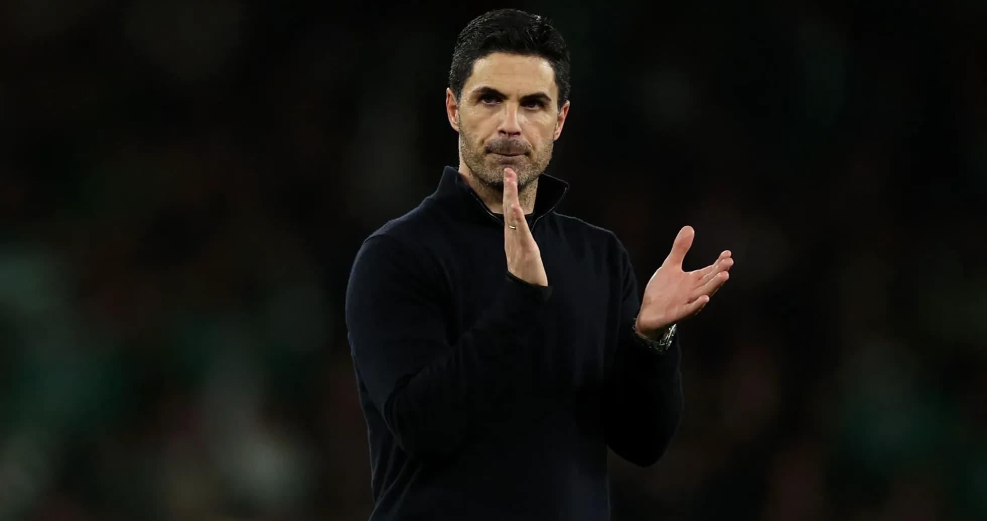 Coach applauding during a match on the sideline