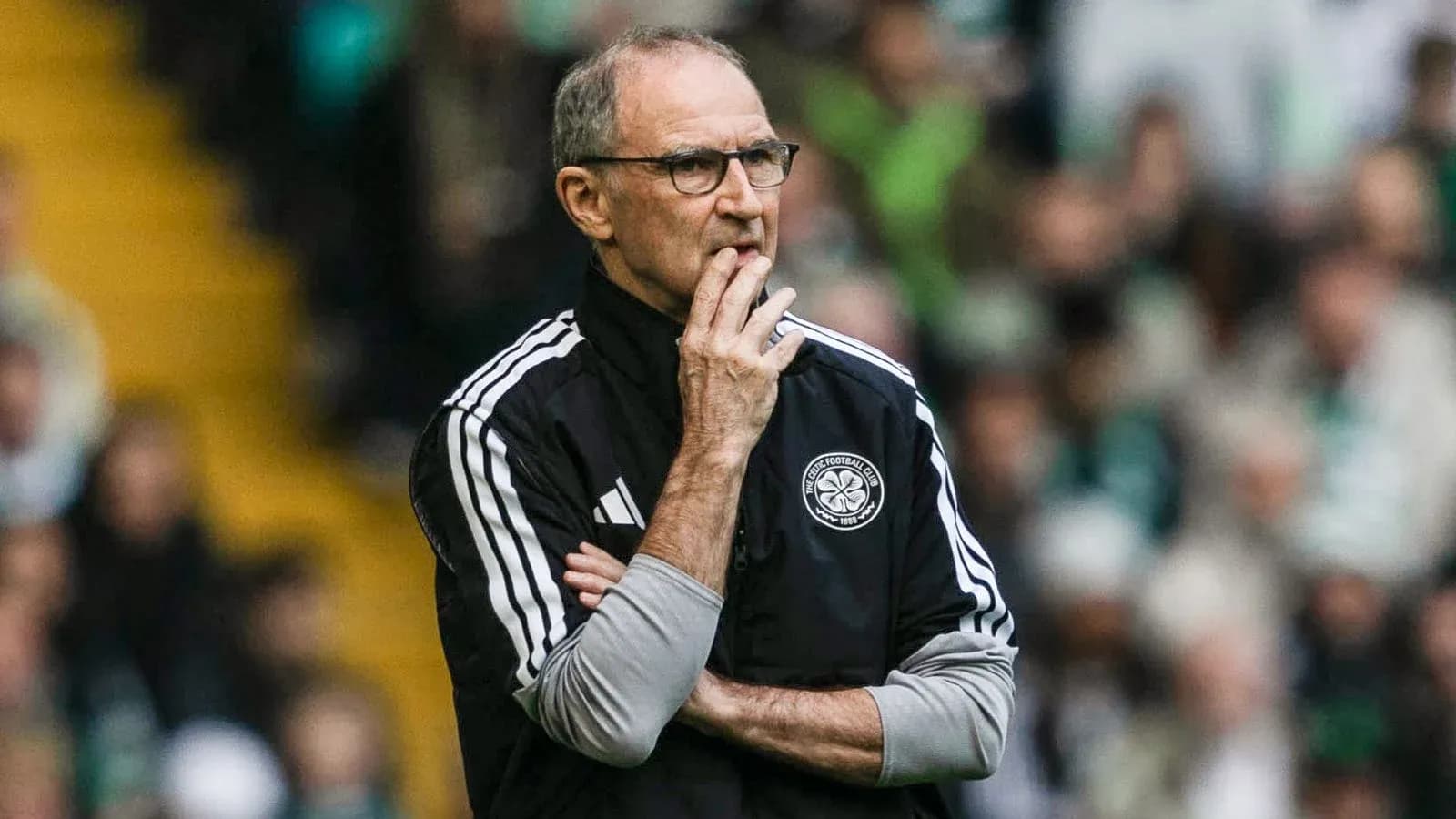 Coach observing the match with thoughtful expression