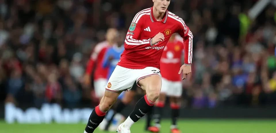Player in red jersey sprinting on the pitch