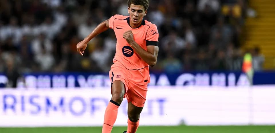Player in pink kit sprinting during a match