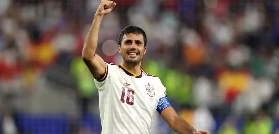 Player celebrating victory with raised fist on field