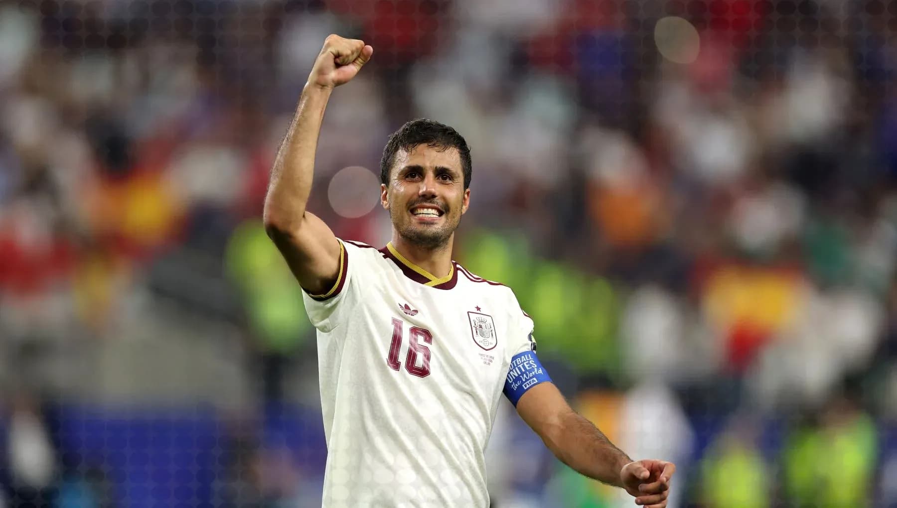 Player celebrating victory with raised fist on field