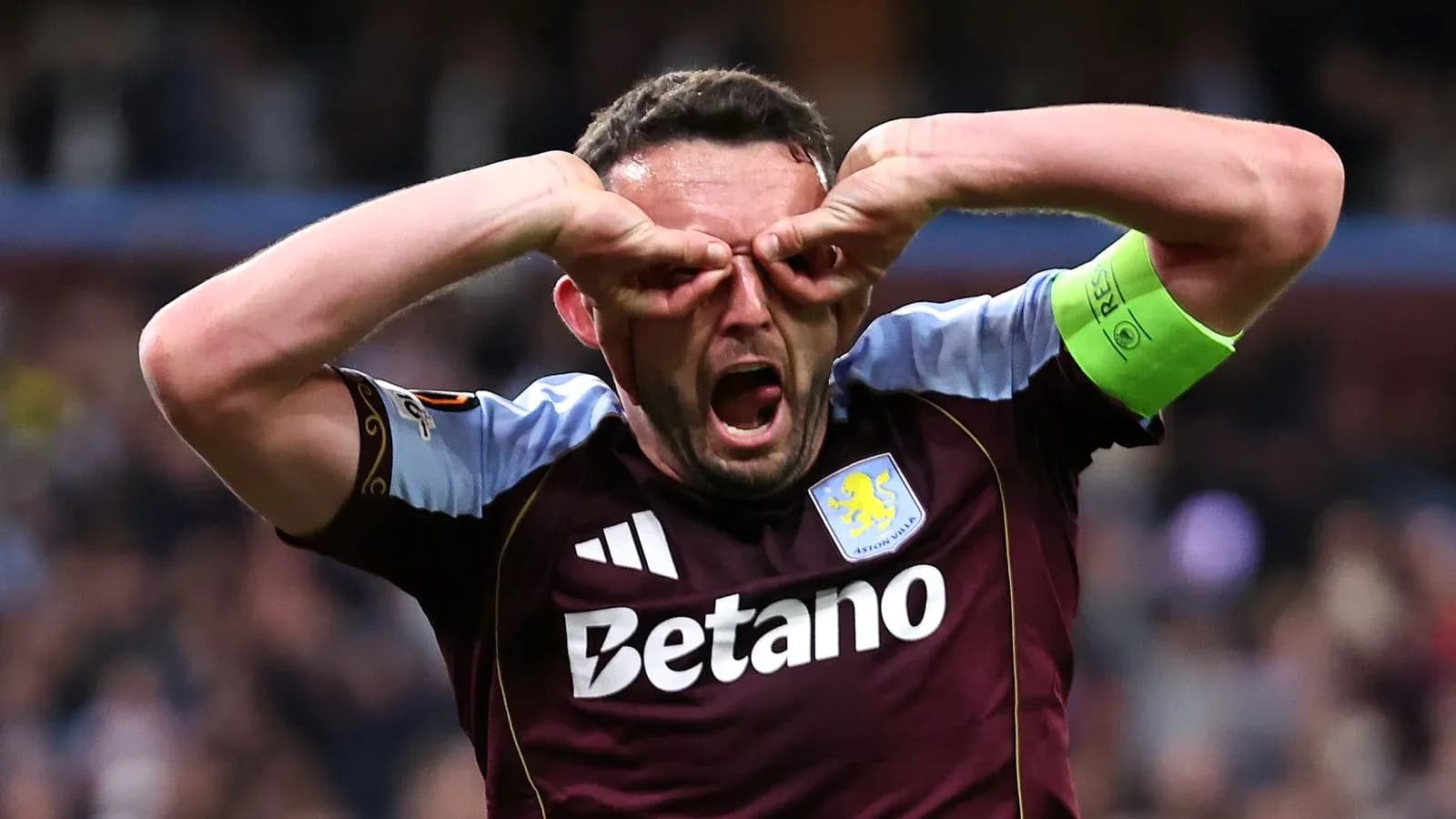 Aston Villa player celebrating with hands on face