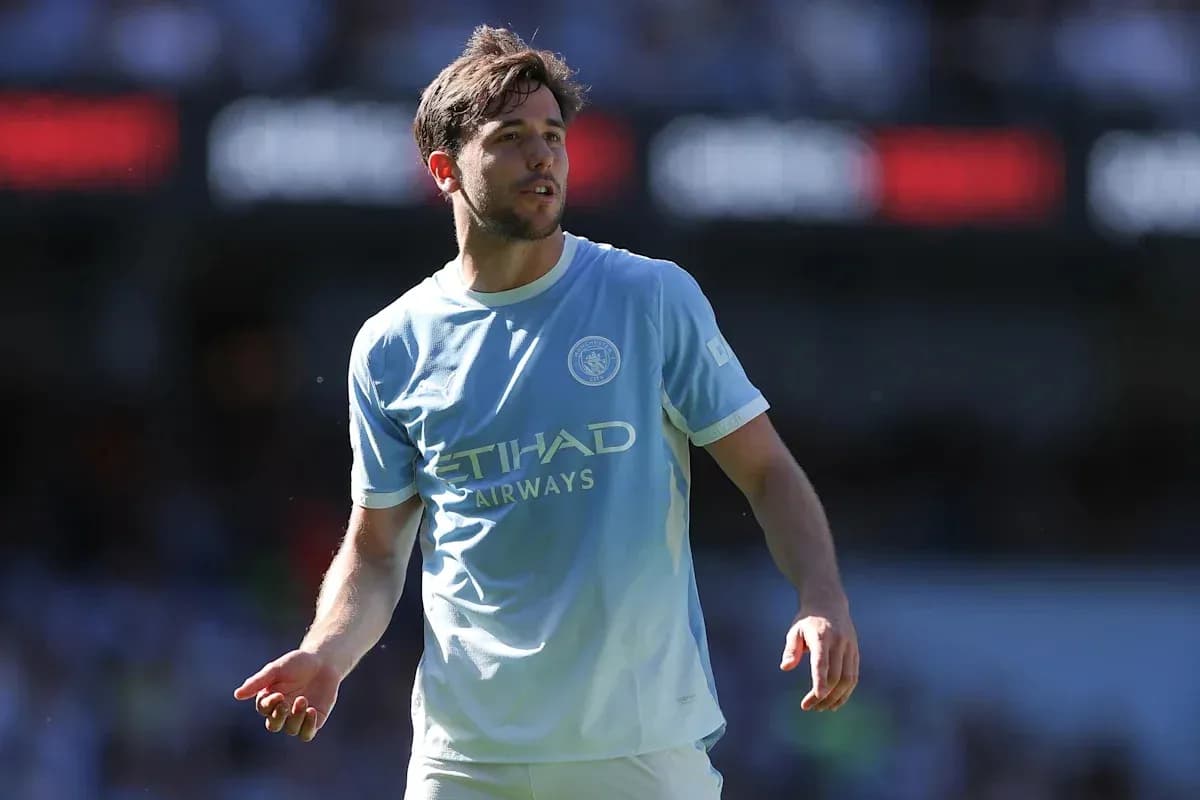 Player in light blue jersey walking on pitch