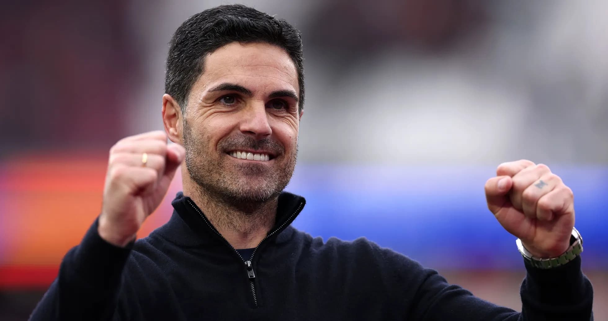 Coach celebrating with clenched fist and smile