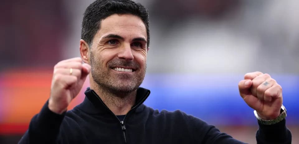 Coach celebrating with clenched fist and smile
