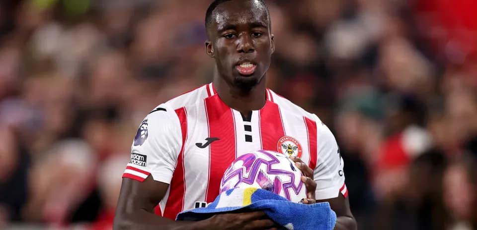 Player holding a ball and towel on field