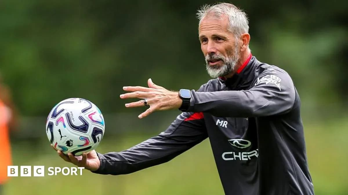 Coach demonstrating a drill with a football