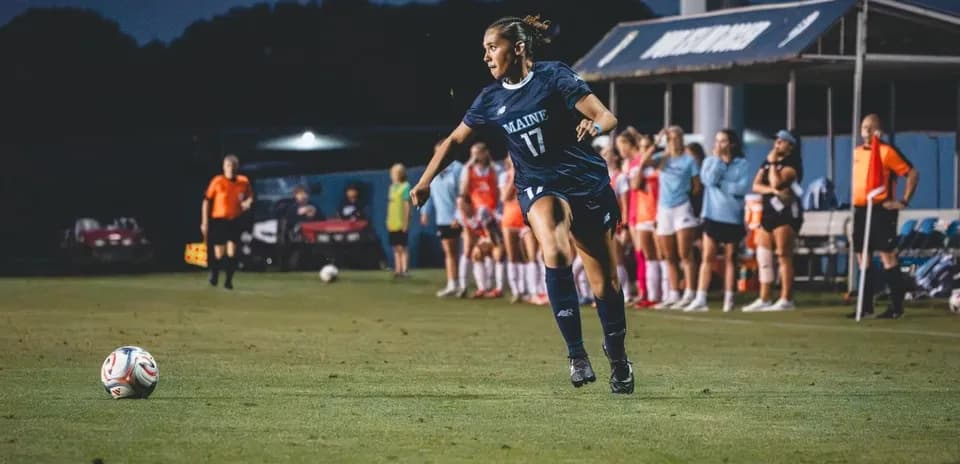 Player from Maine preparing to kick the soccer ball