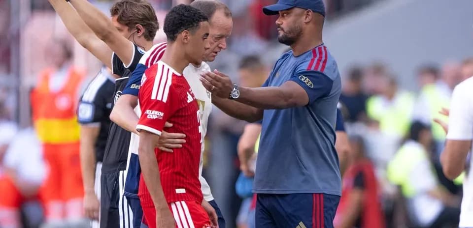 Coach talking to player during substitution on field