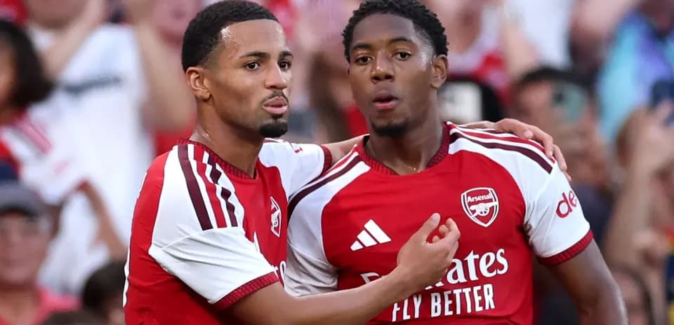 Two Arsenal players celebrating a goal together