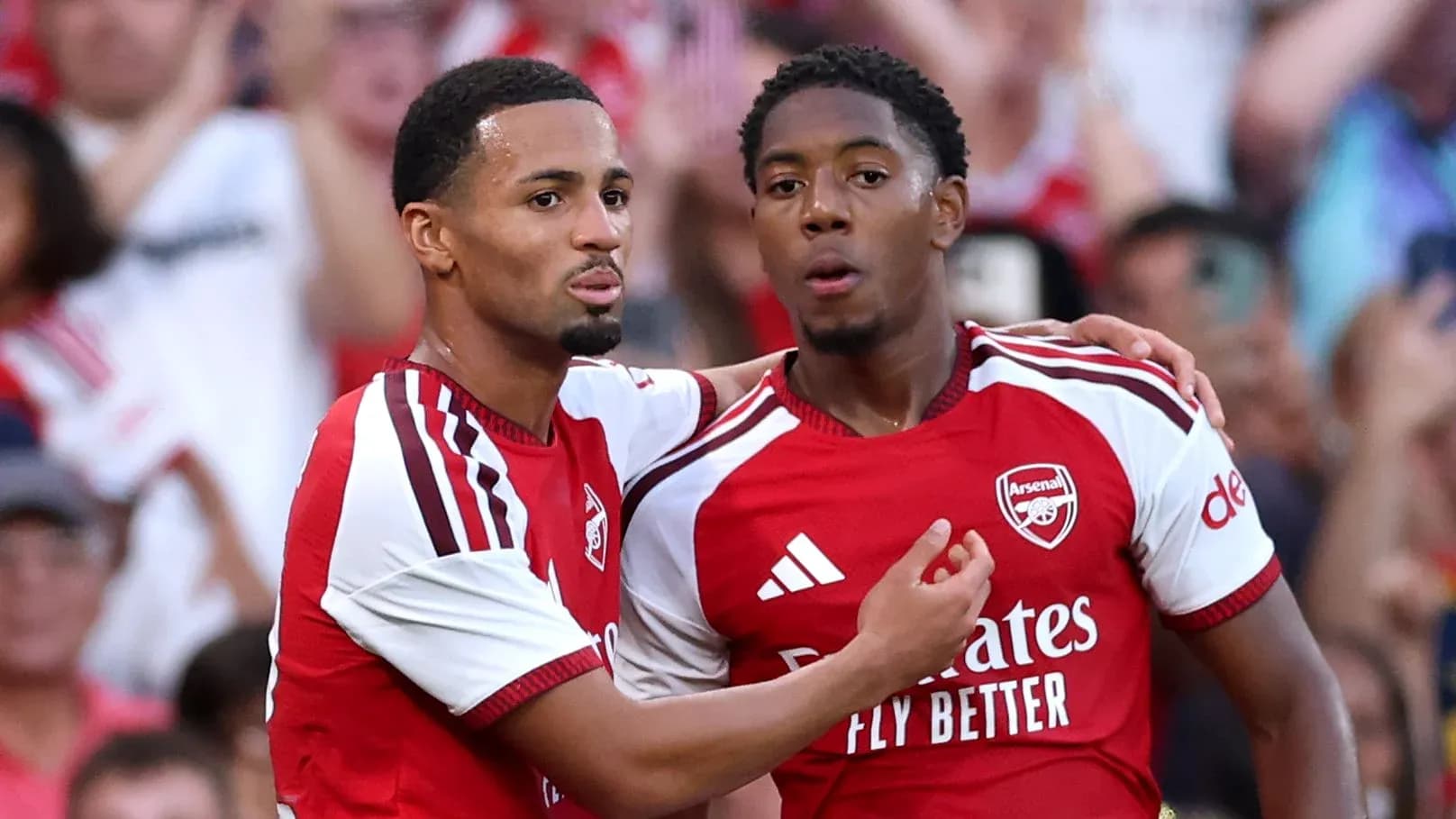Two Arsenal players celebrating a goal together
