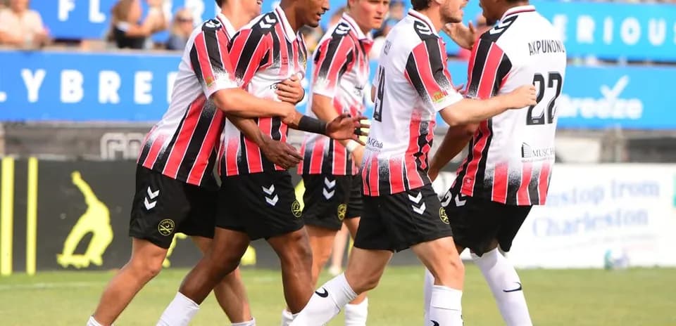 Players celebrating a goal during USL Championship match