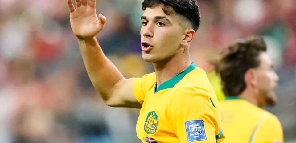 Player gesturing during a match in yellow jersey