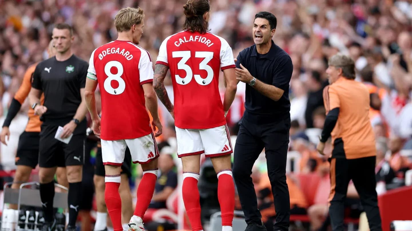 Arsenal players receiving instructions from the coach