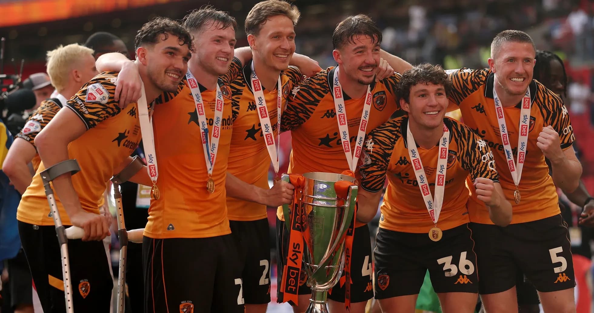 Players celebrating with trophy after winning match