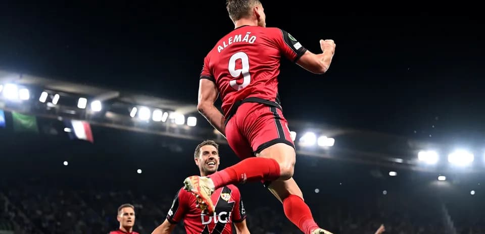 Player celebrating a goal with teammates on field