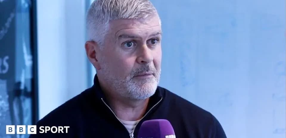 Man speaking into microphone during interview
