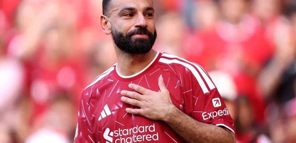 Player in red jersey gestures to crowd