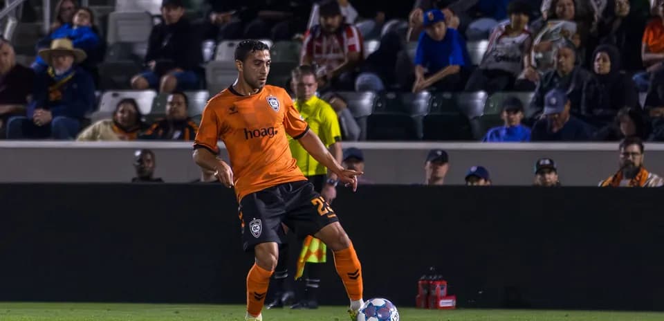 Player from Orange County SC dribbling ball