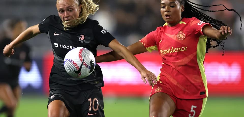 Players competing for the ball in NWSL match